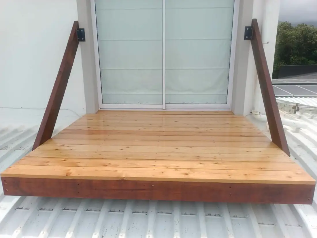 Small deck platform with angled timber struts at a doorway