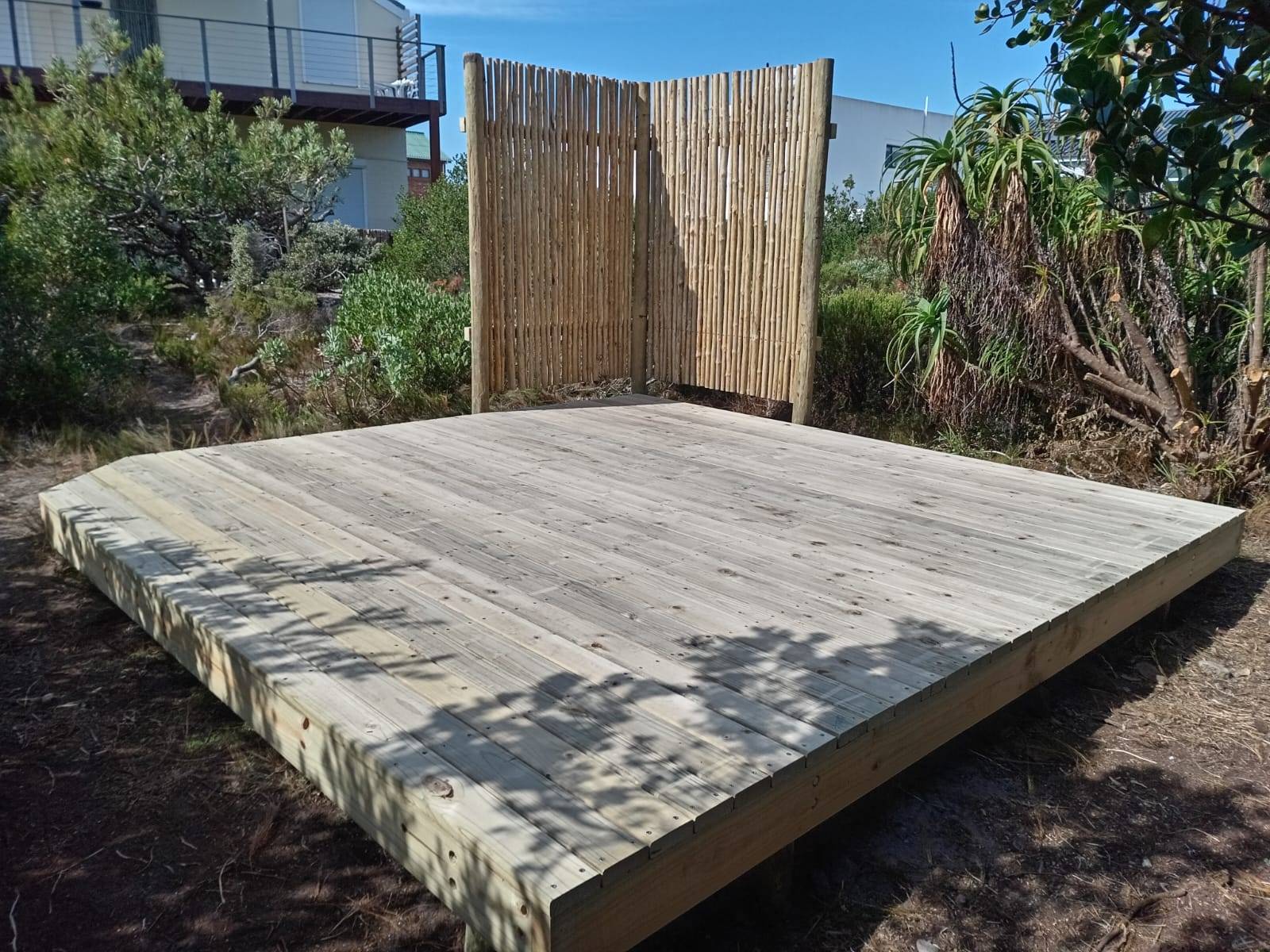 Raised deck platform with privacy screening behind it