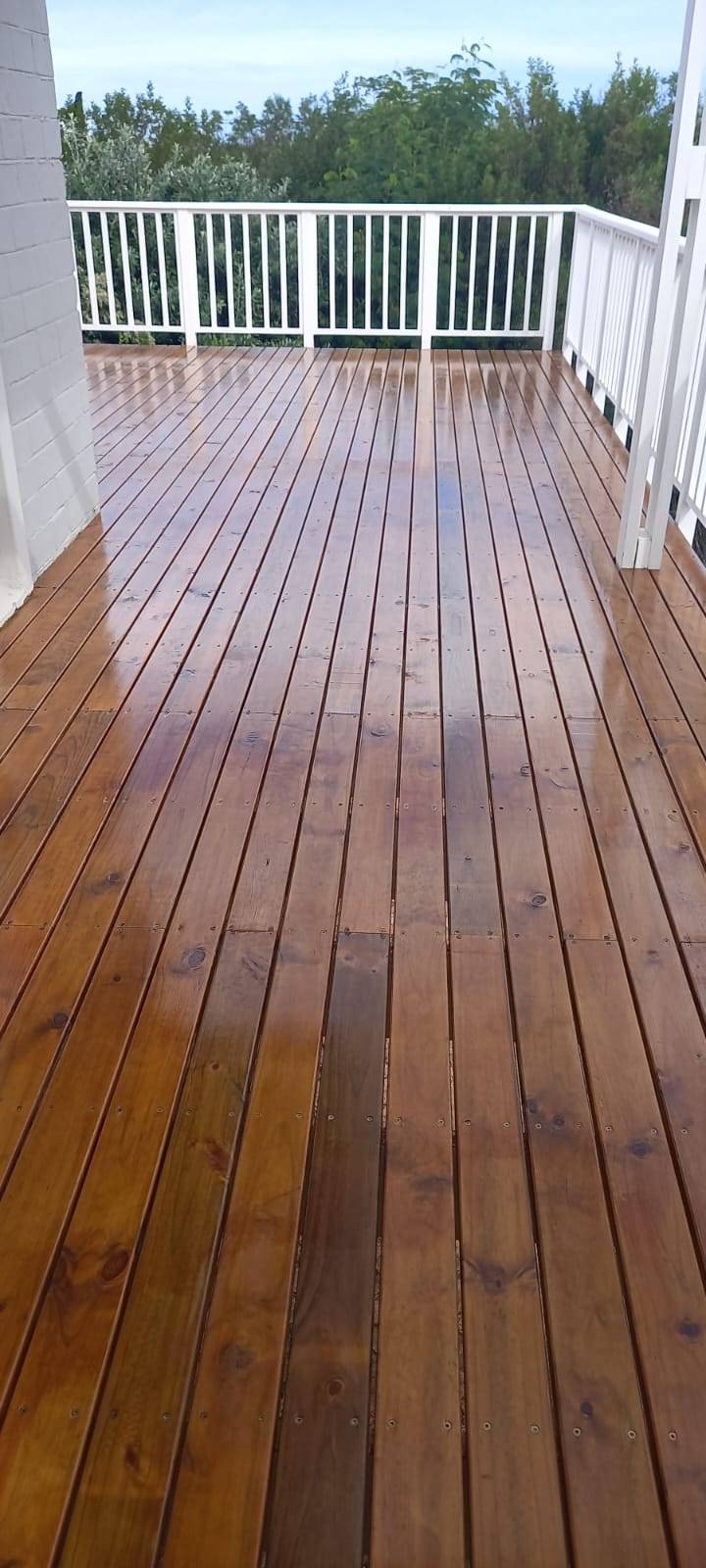 Glossy stained deck with white balustrade
