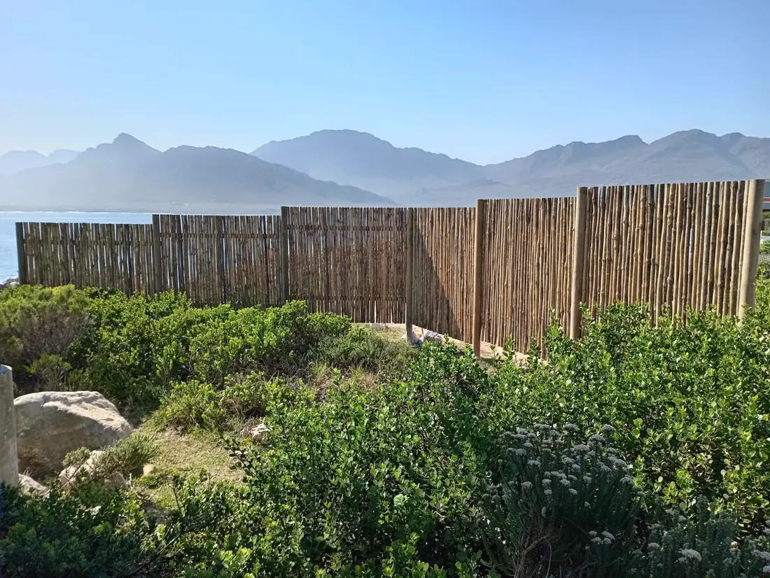 Timber dropper fence with mountains in the distance