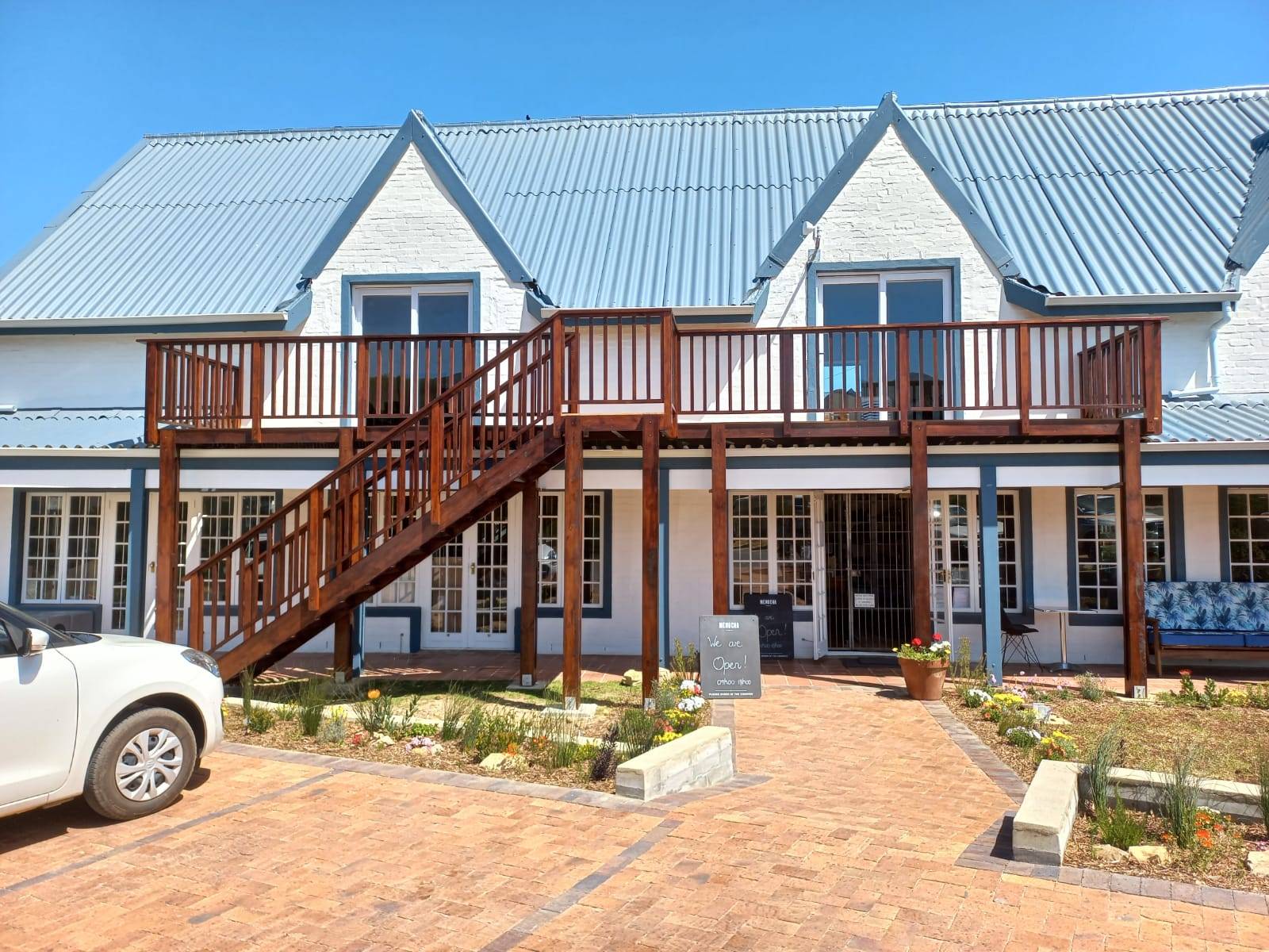 Timber staircase leading up to a house balcony